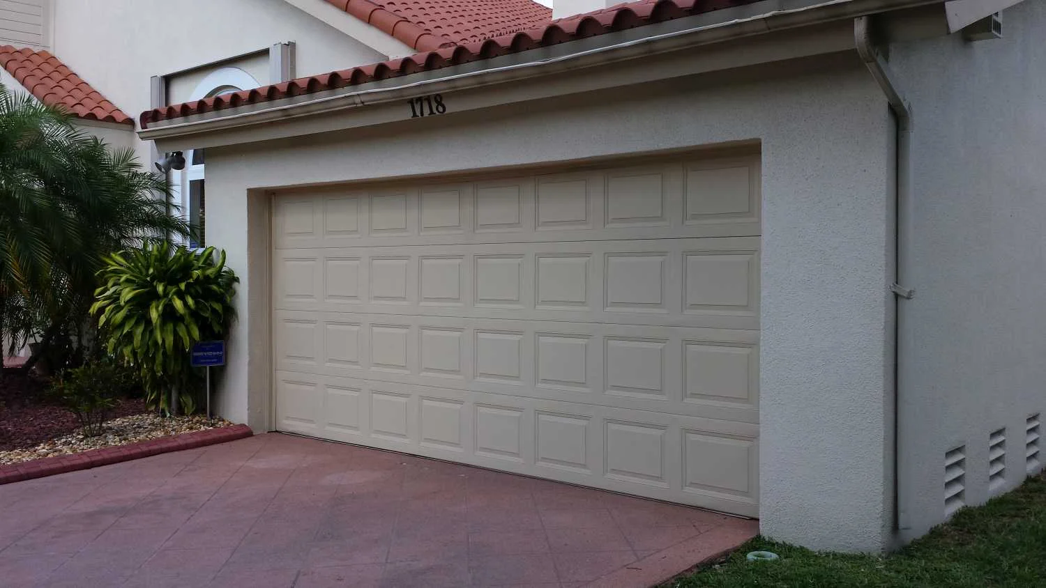Garage door before AstroGuard hurricane protection installation — Los Cabos